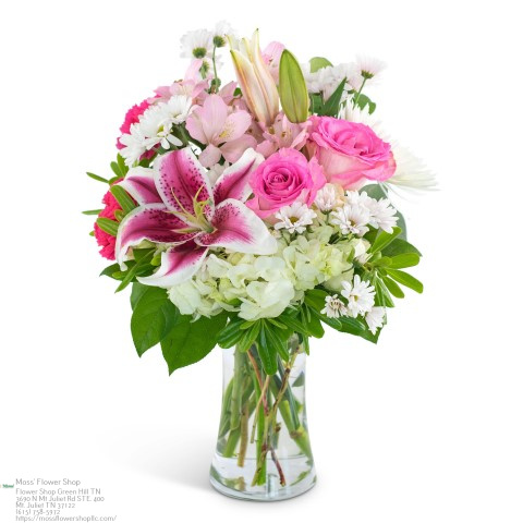Pink rose, daisy and lilies arrangement in glass vase